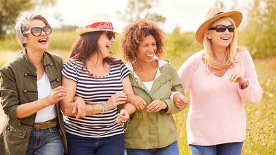 Women walking arm in arm