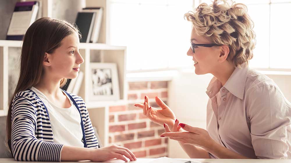 woman talking with young girl