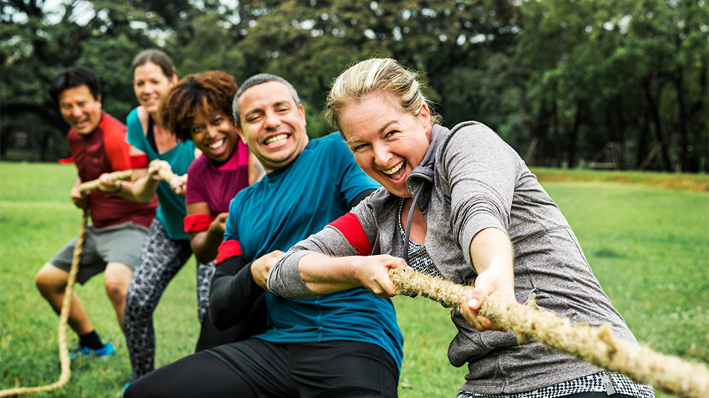 group of friends playing tug of war